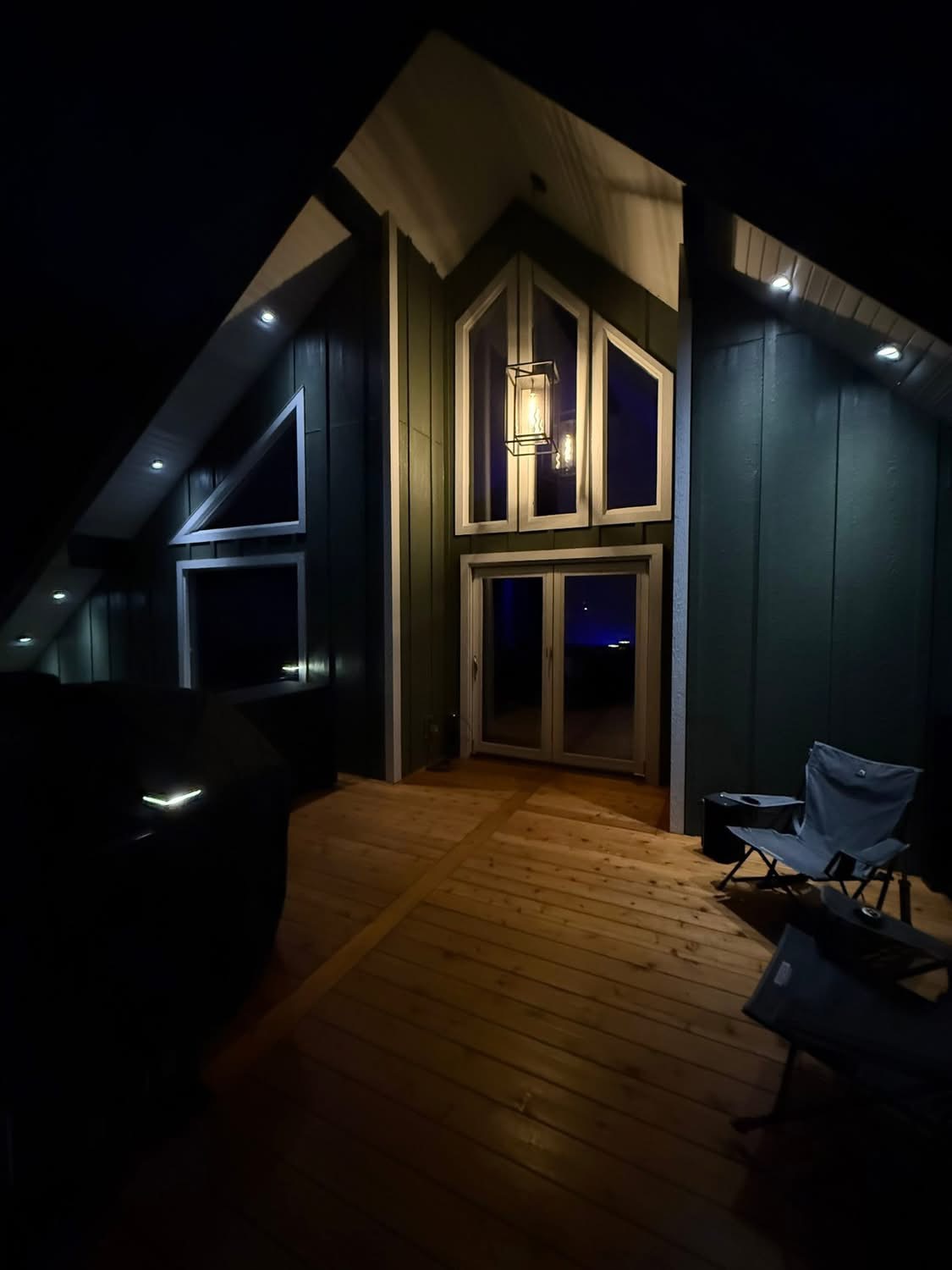 Outdoor deck lighting installation at night